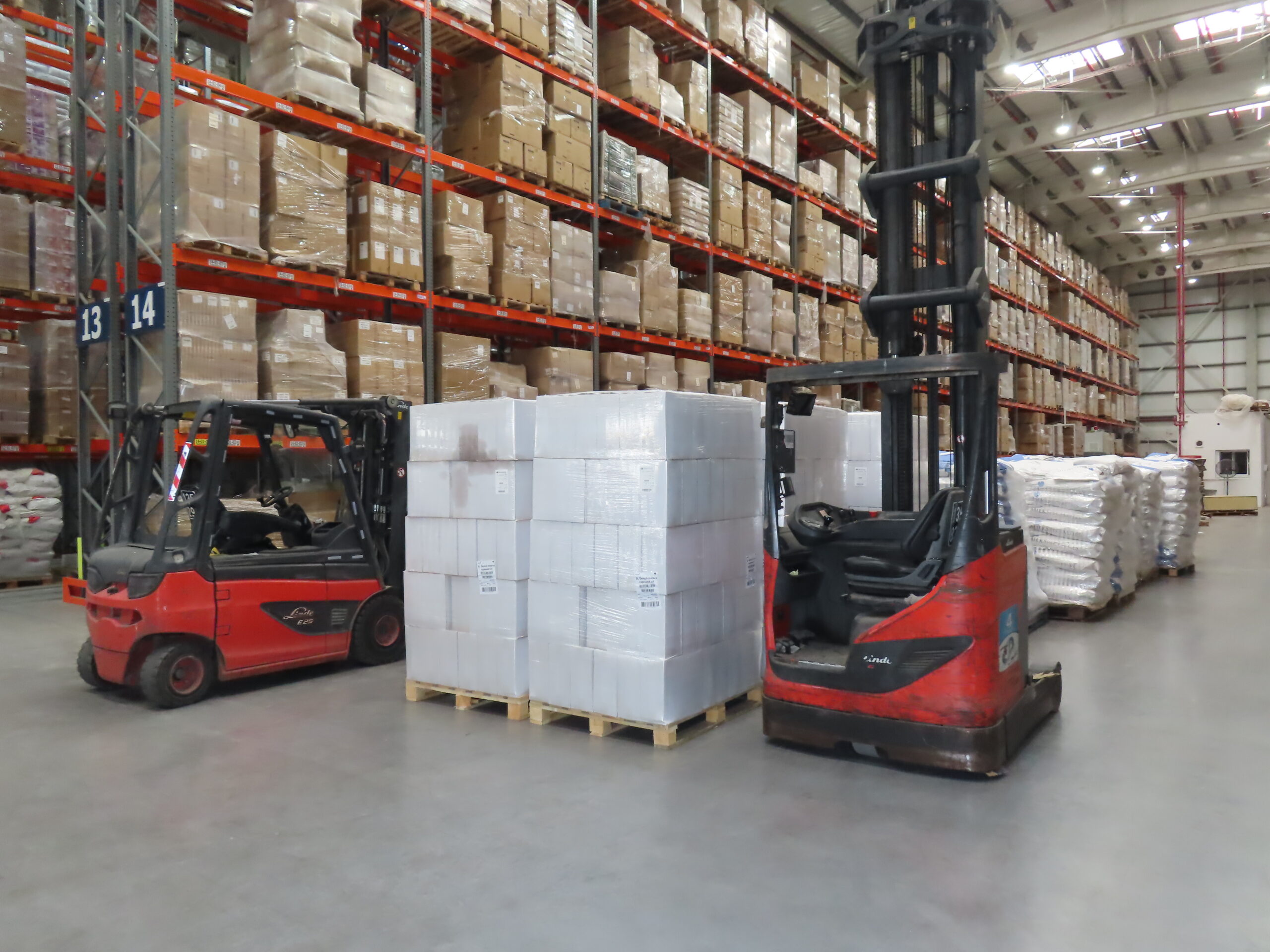 Forklift moving a pallet on the warehouse floor